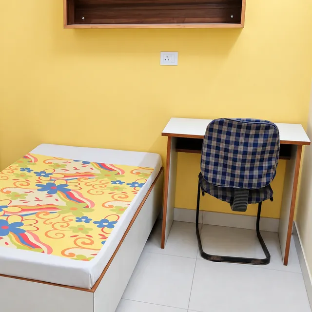 Bed beside a dedicated study desk and chair
