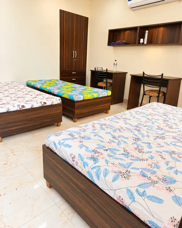 Shared bedroom with individual beds and study desks